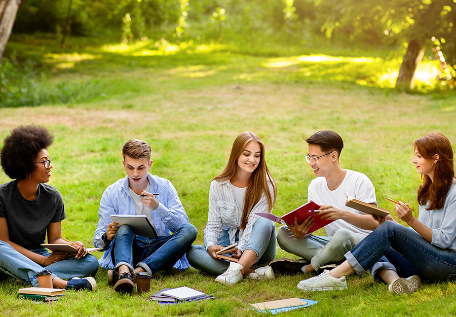 A gathering of teenage or young adult students in a park